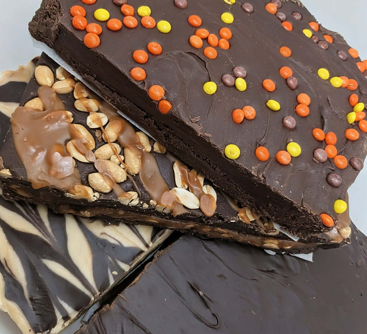 Homemade chocolate fudge with nuts and candy toppings sold by the pound